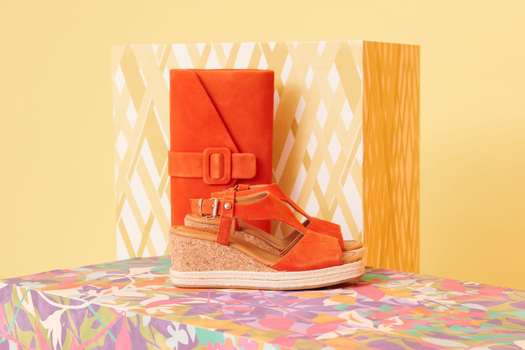 Matching orange sandals and clutch bag